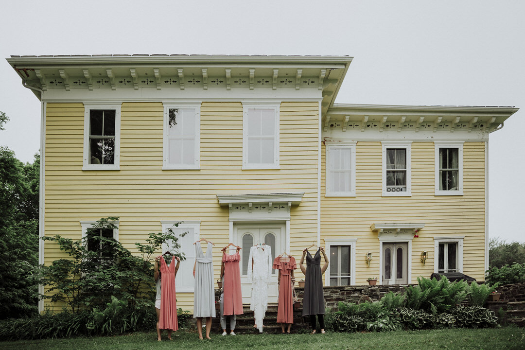 bridesmaids holding their dresses