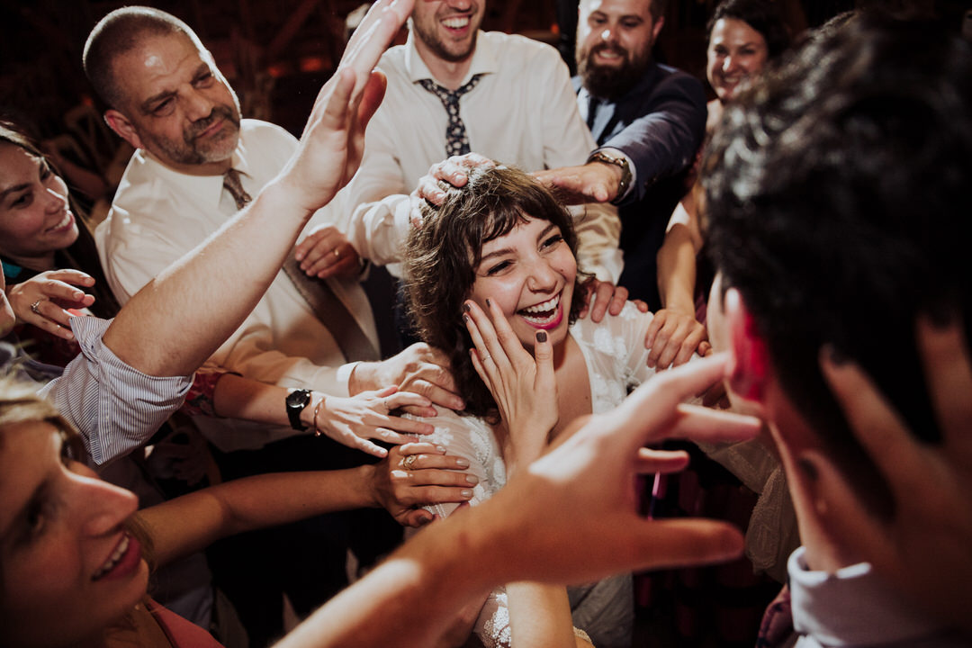 bride surround by family and laughing