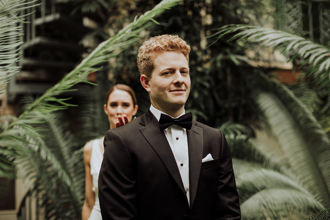 groom smiling before seeing bride