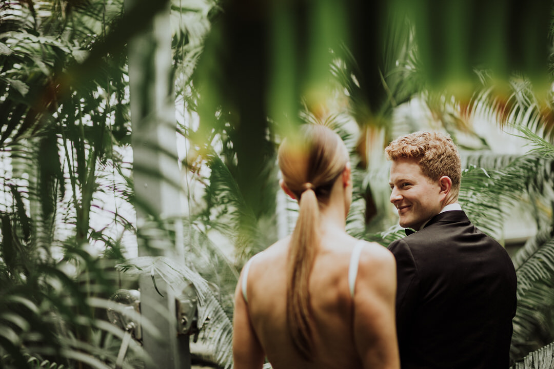 groom smiling at bride during first look