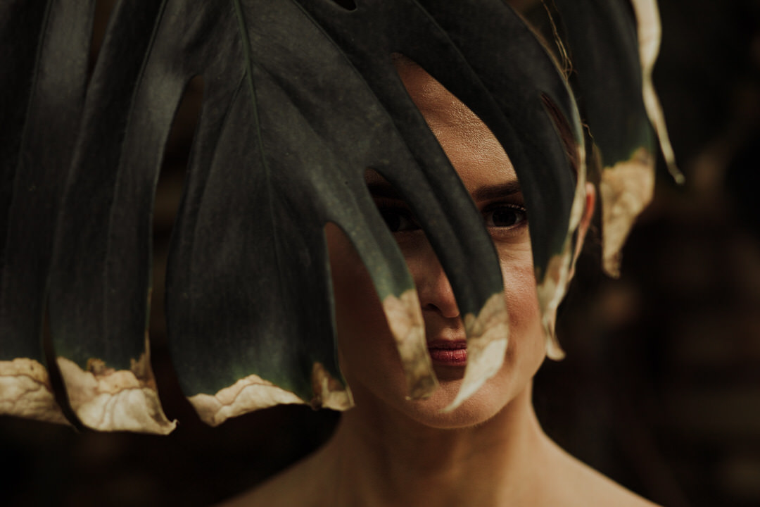 creative portrait of bride behind leaf