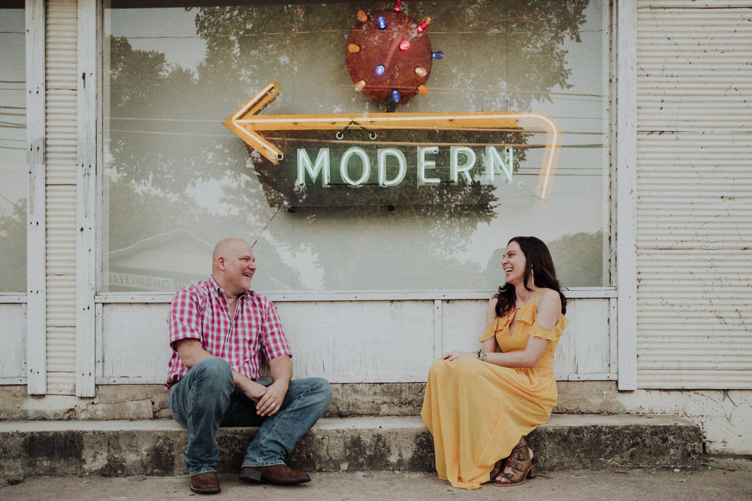 couple laughing on the sidewalk