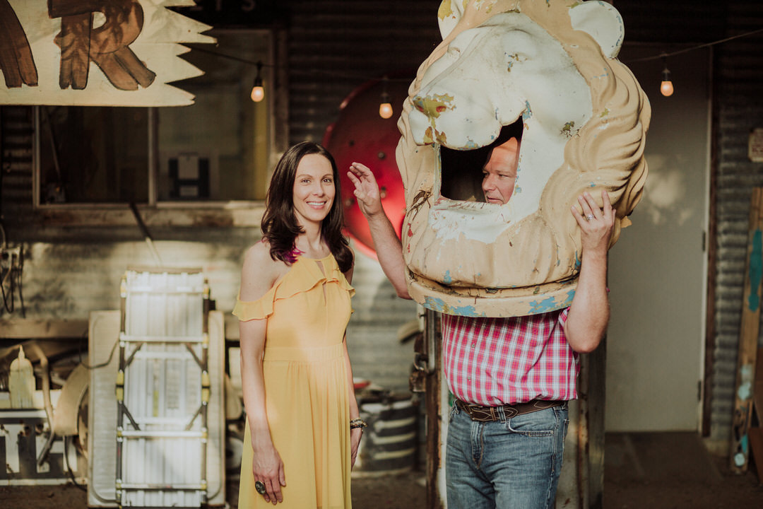 groom making bride laugh with lion head