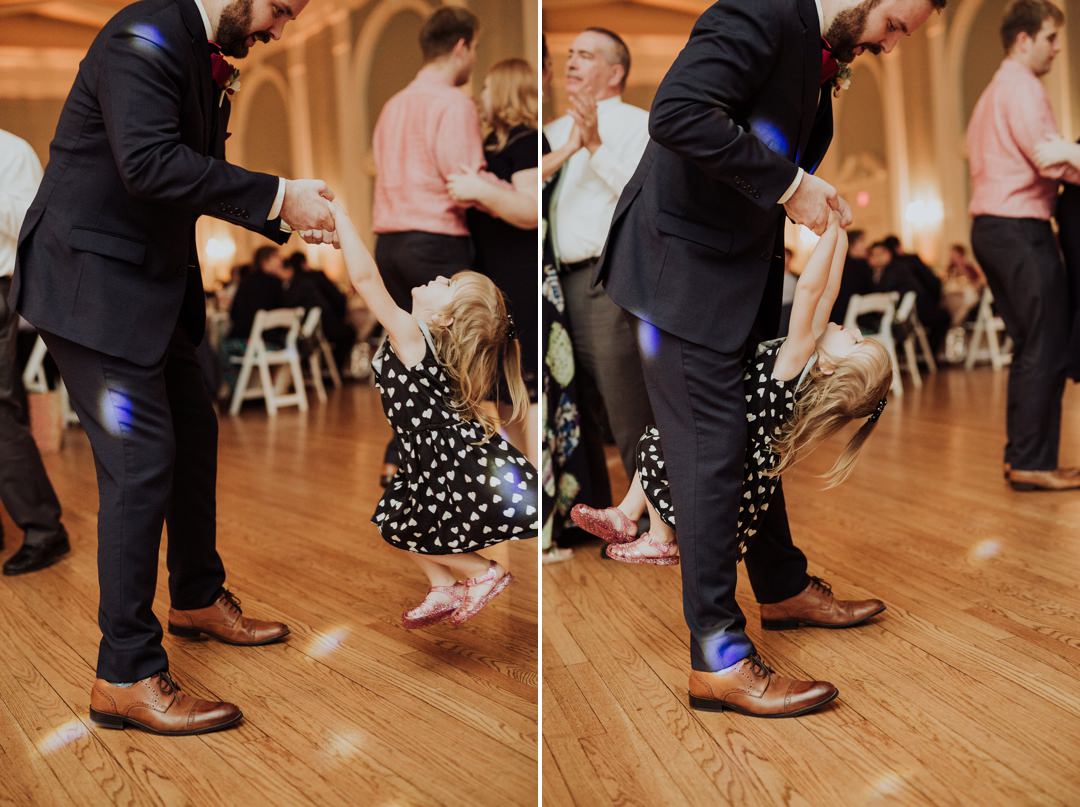 groom dancing with flower girl