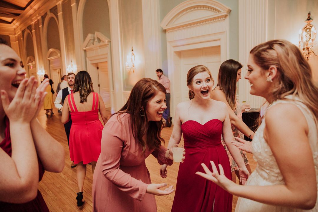 bridesmaids laughing with bride