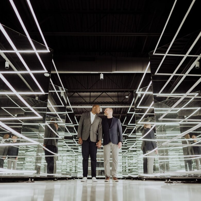 Paul and Donnie’s LGBTQ engagement photos inside the mirror room at Wonderspaces Austin