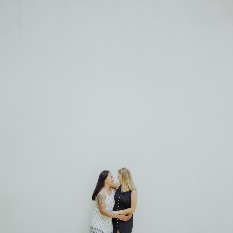 Christine and Taylor embracing after a surprise LGBTQ proposal at Sekrit Theatre in Austin