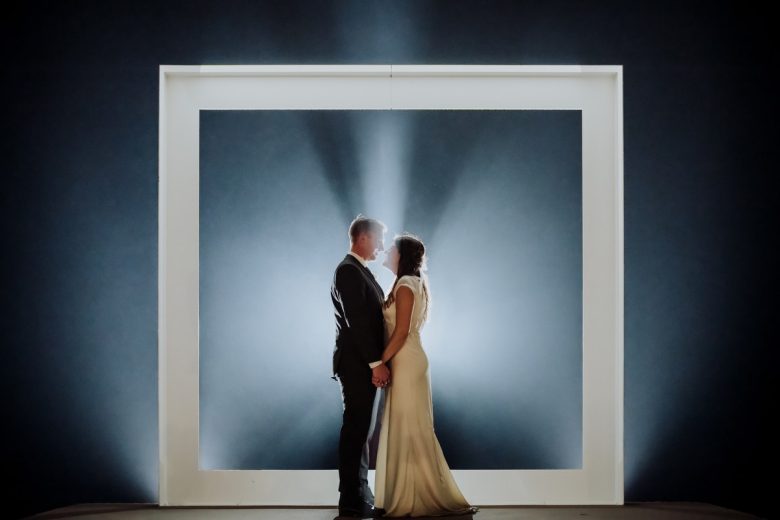 Bride and groom silhouetted in a glowing frame at Prospect House